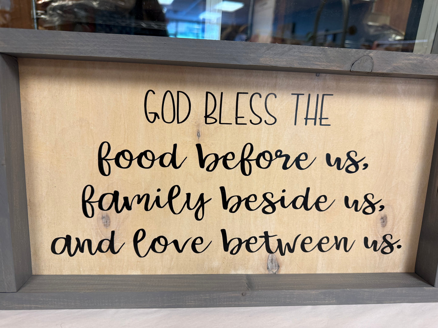 Wooden wall art “God bless the food before us, family beside us, and love between us.”